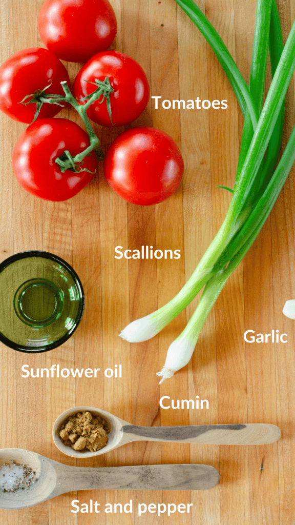 foto of all the ingredients to make colombian hogao: tomatoes, scallions, sunflower oil, garlic, cumin,salt and pepper 
