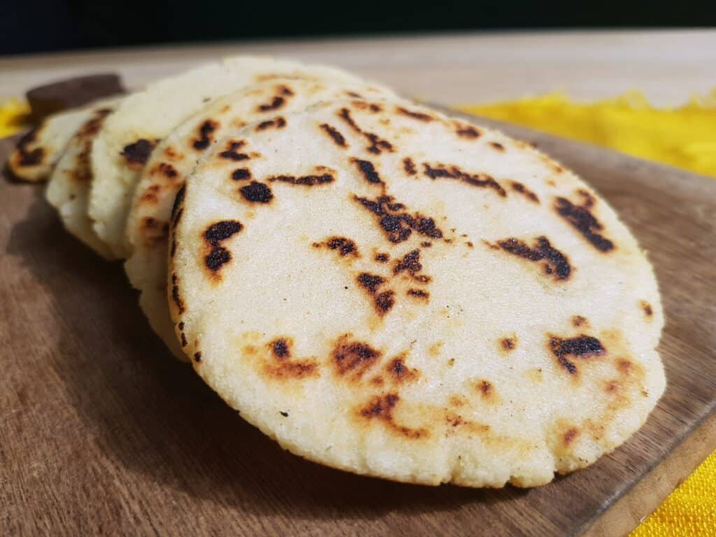 stack of arepas on a cutting board