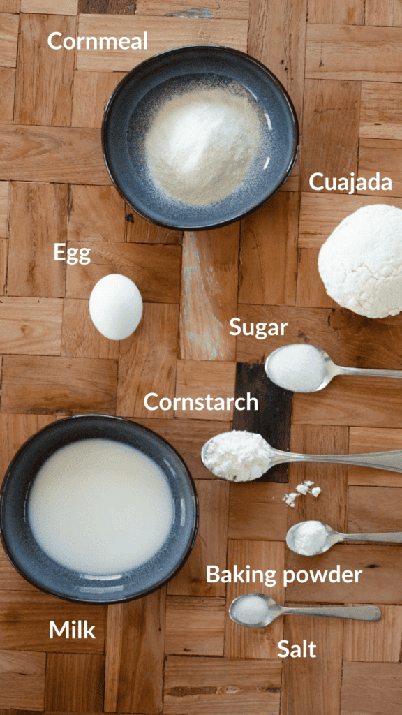 a picture with the ingredients: cornmeal, cuajada, egg, sugar, cornstarch, baking powder, salt and milk