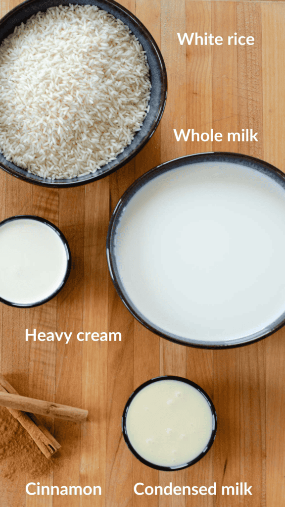 shot of the ingredients for arroz con leche: rice, whole milk, heavy cream, condensed milk, cinnamon