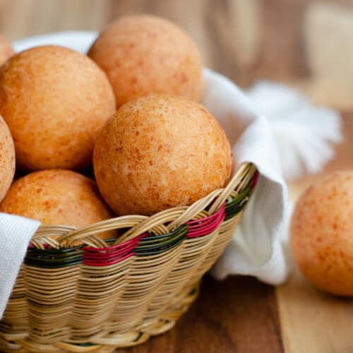 Colombian Buñuelos in a traditional basket lined with a white towel