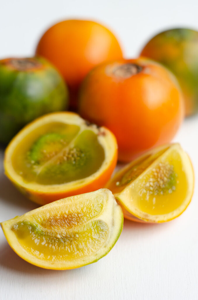 lulo naranjilla fruit and one cut to show the orange inside