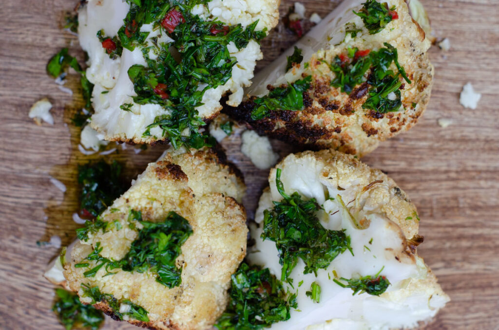 top view of bbq grilled cauliflower with chimichurri