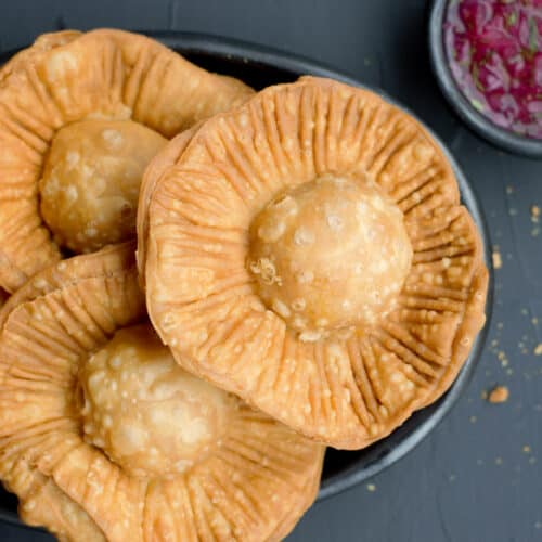 colombian fried chickpea pasties pasteles de garbanzos in a plate with onion salsa