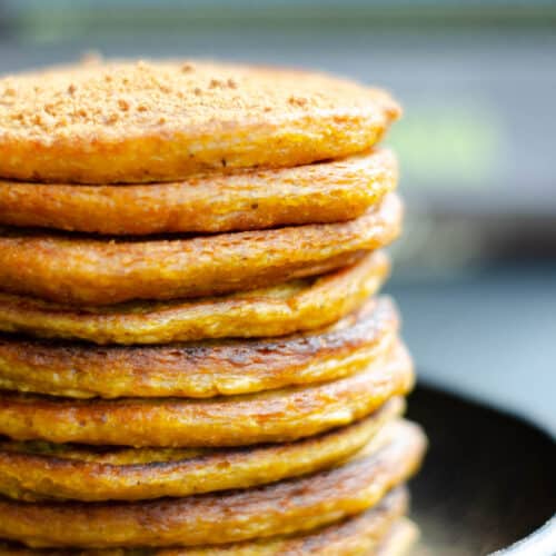 stack of vegan pumpkin pancakes on a dark plate