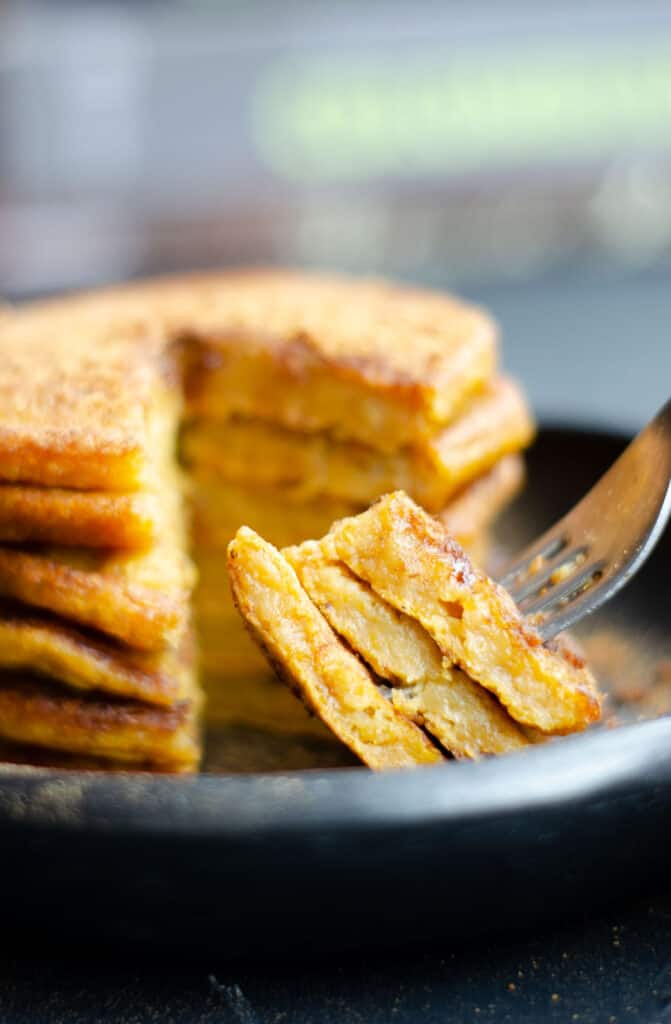 stack of vegan caribbean pumpkin pancakes cut open to show the moist inside