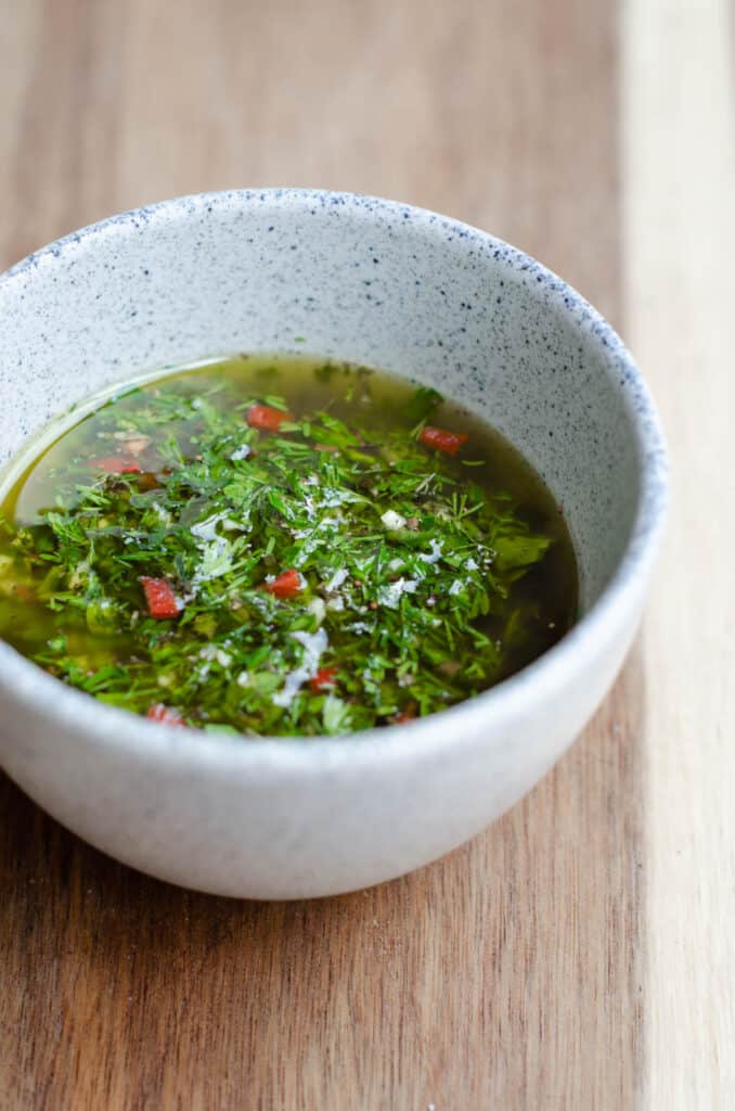 white bowl with green chimichurri sauce