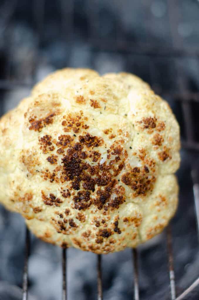 whole roasted cauliflower on a grill