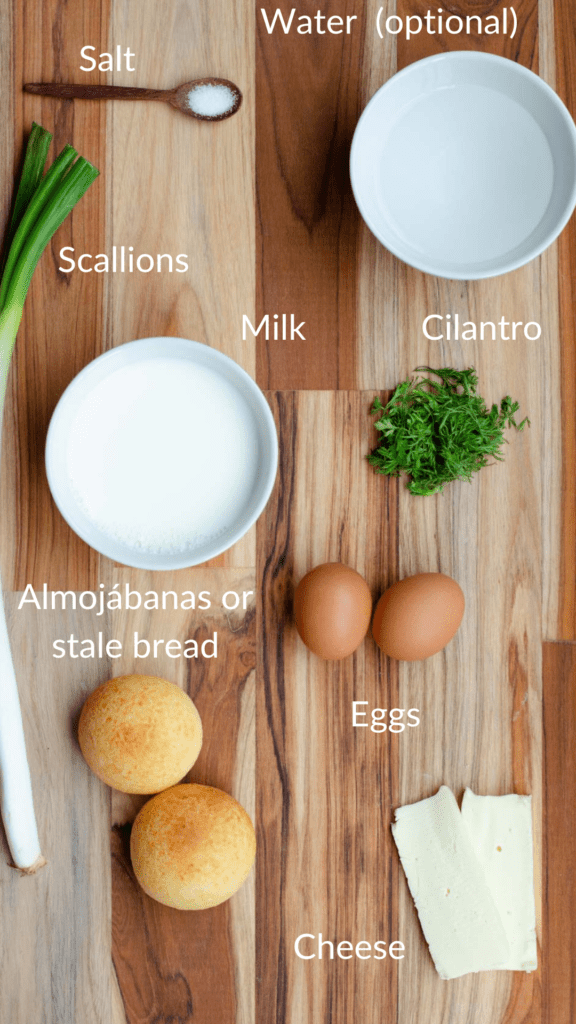ingredients of changua in one board, milk, water, scallions, eggs, cilantro, salt, eggs, almojabanas