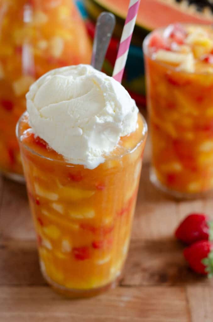 a glass of salpicon with a scoop of vanilla ice cream on top